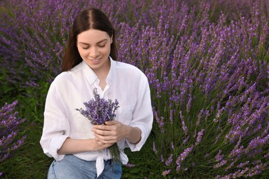 Photo of Smiling woman with bouquet in lavender field. Space for text