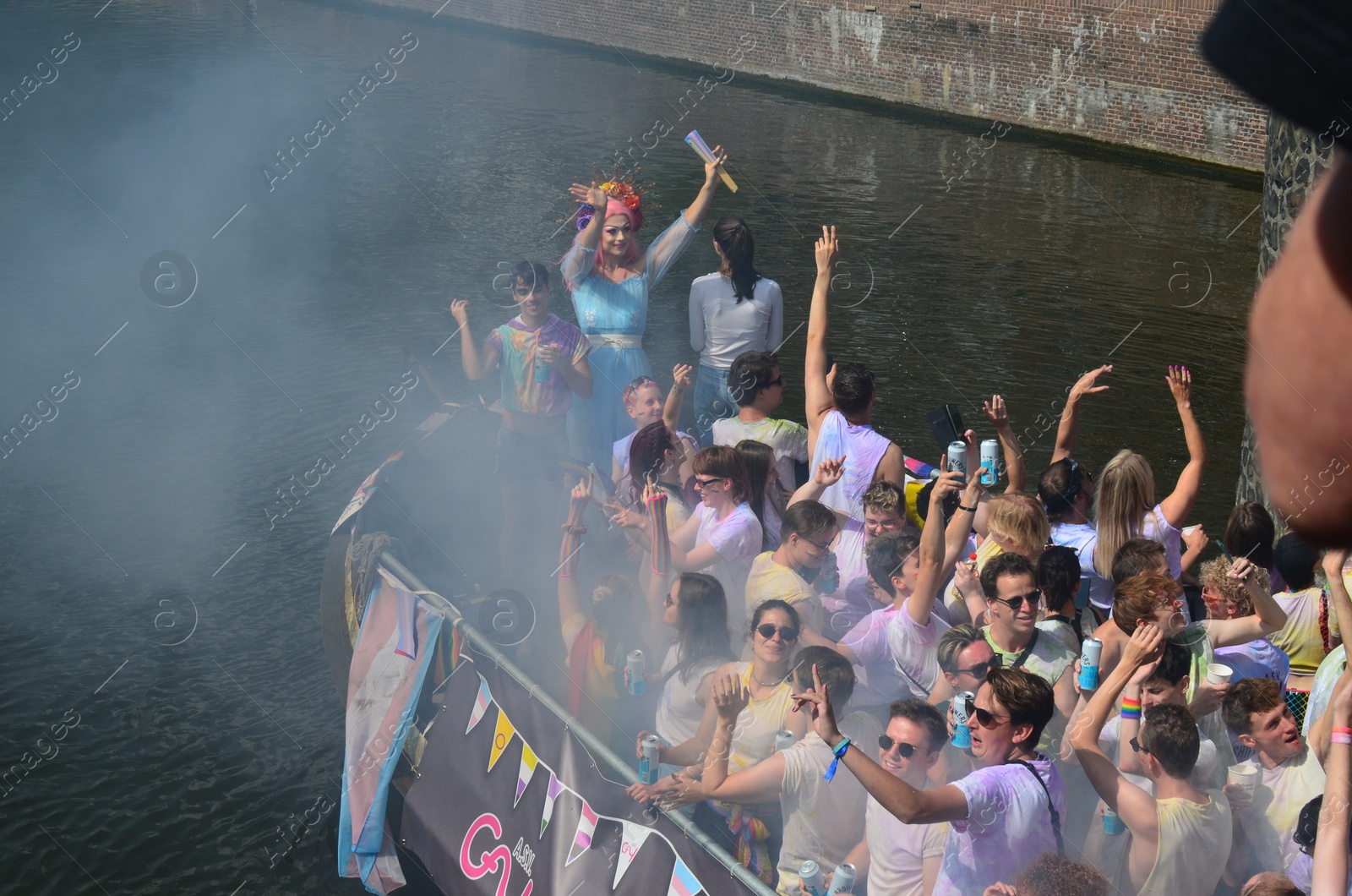 Photo of AMSTERDAM, NETHERLANDS - AUGUST 06, 2022: Many people in boat at LGBT pride parade on river