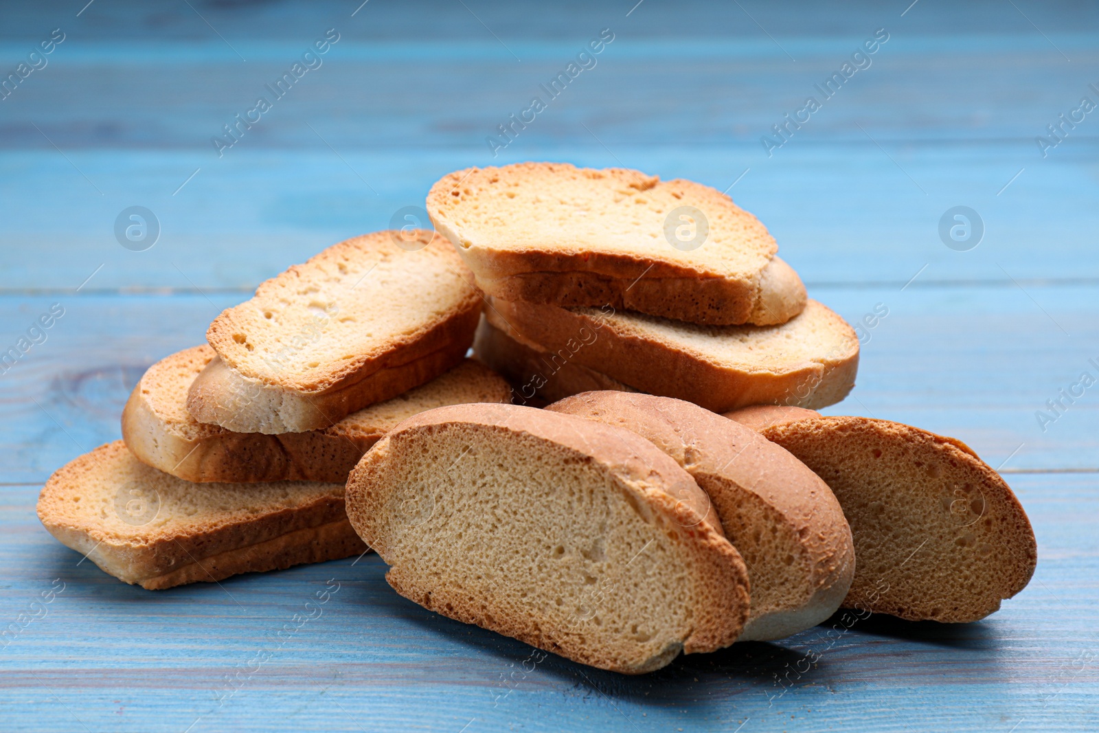 Photo of Hard chuck crackers on light blue wooden table