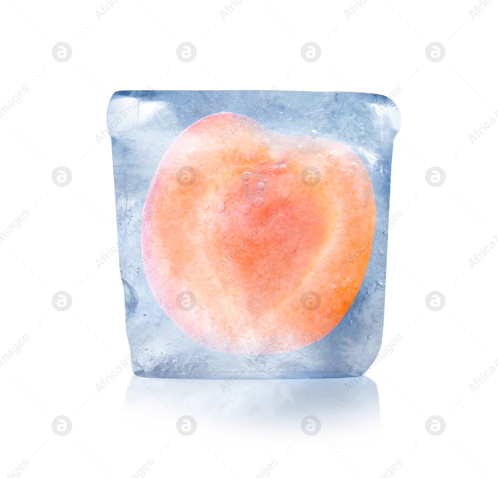 Image of Frozen food. Raw apricot in ice cube isolated on white