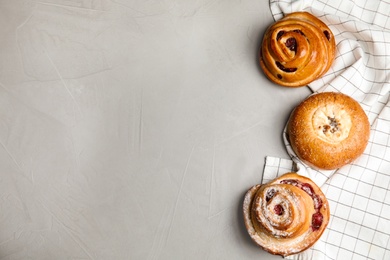 Photo of Different pastries on grey background, flat lay. Space for text