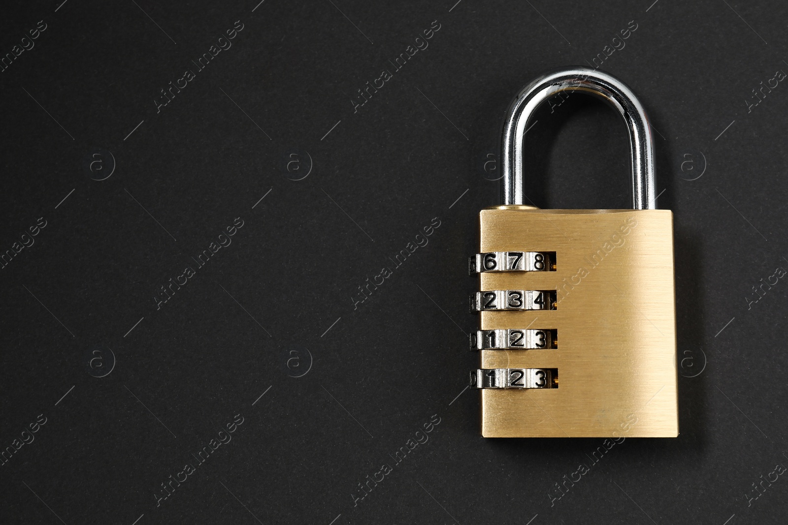 Photo of One steel combination padlock on black background, top view. Space for text