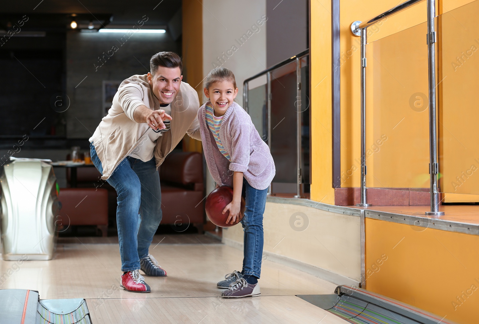 Photo of Father and daughter spending time together in bowling club