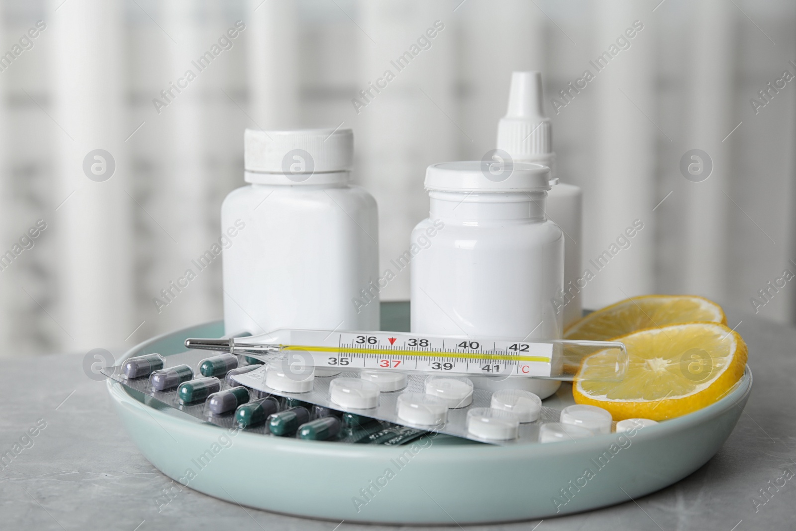 Photo of Different cold remedies on light grey marble table
