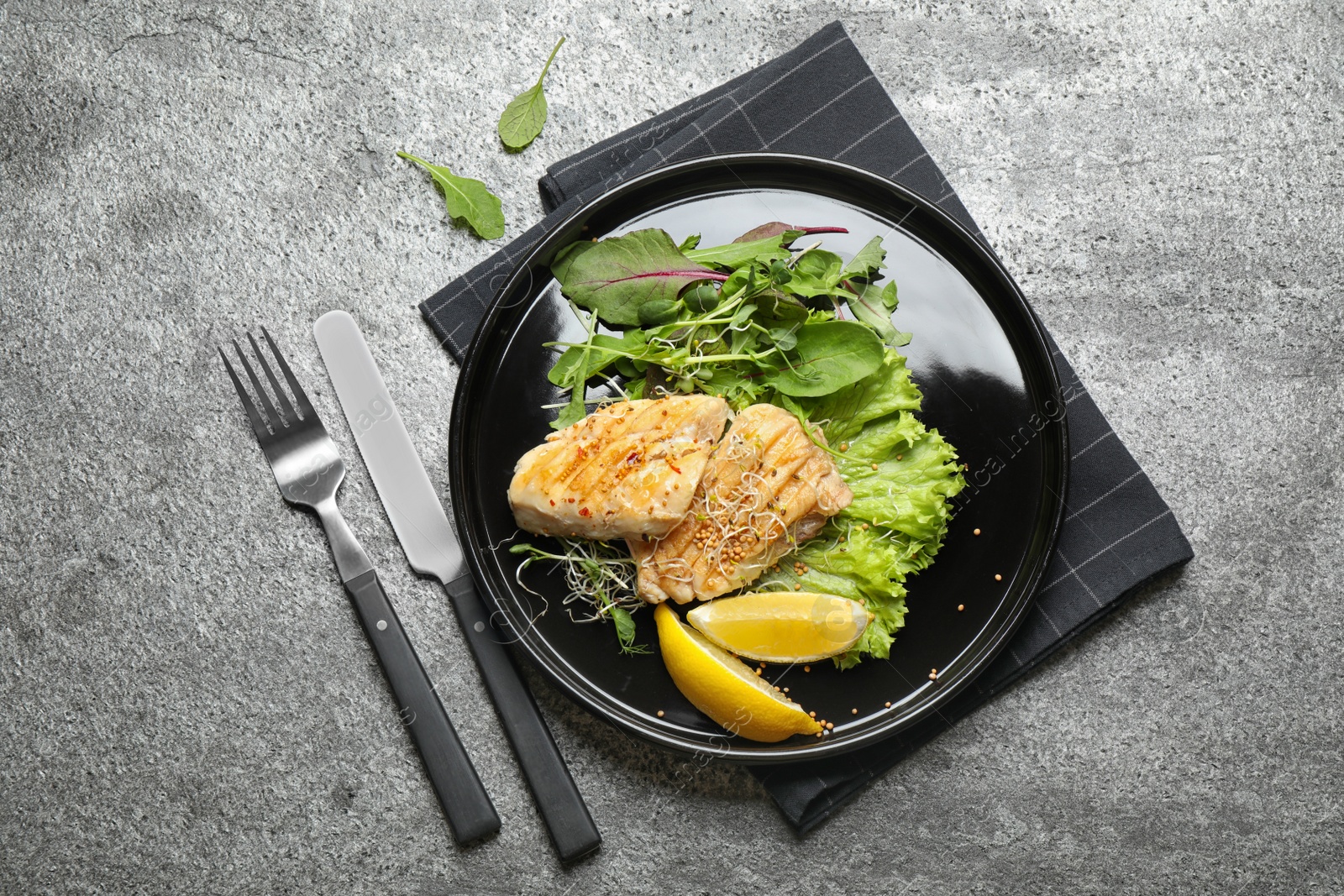 Photo of Tasty grilled fish on grey table, flat lay