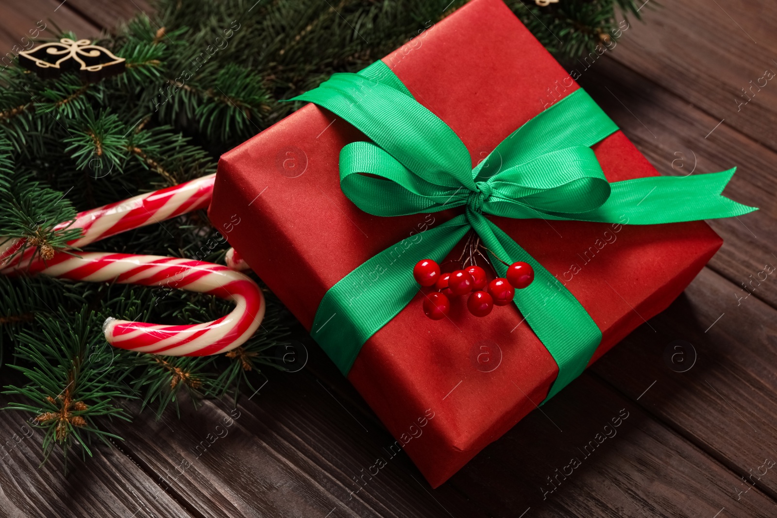 Photo of Christmas composition with gift box and festive decor on wooden table