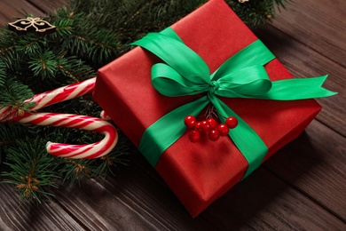 Christmas composition with gift box and festive decor on wooden table