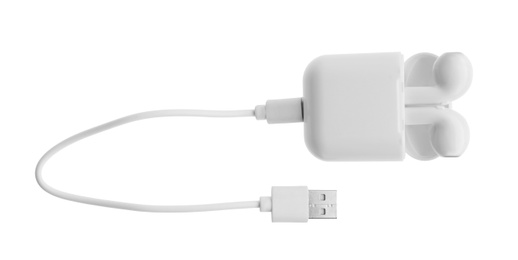 Photo of USB charge cable and wireless earphones on white background. Modern technology