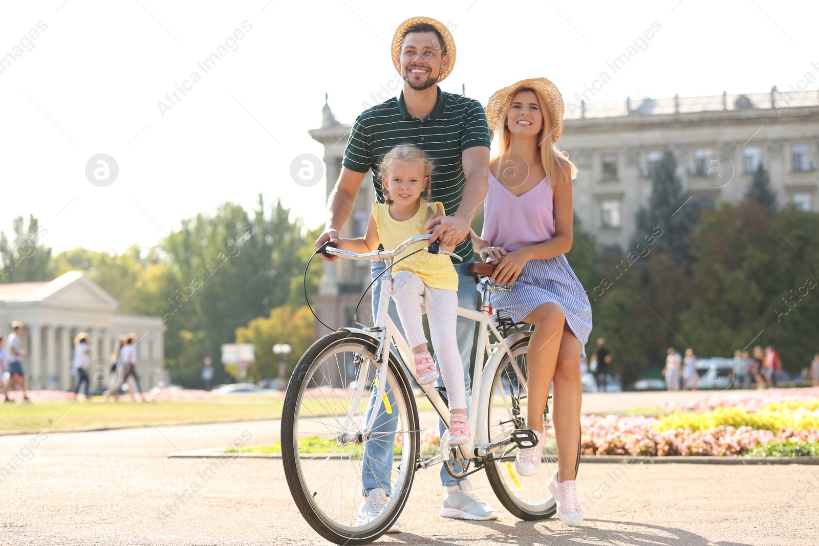 Photo of Happy family with bicycle outdoors on summer day