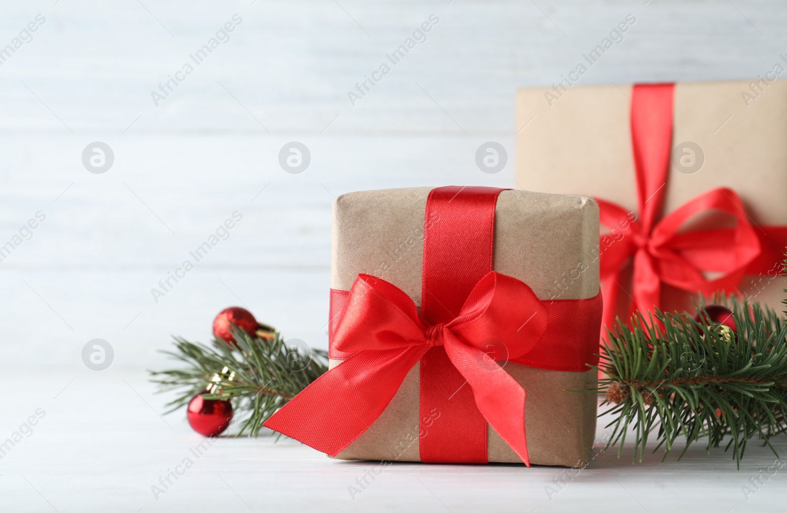 Photo of Gift boxes and Christmas decorations on white table, space for text