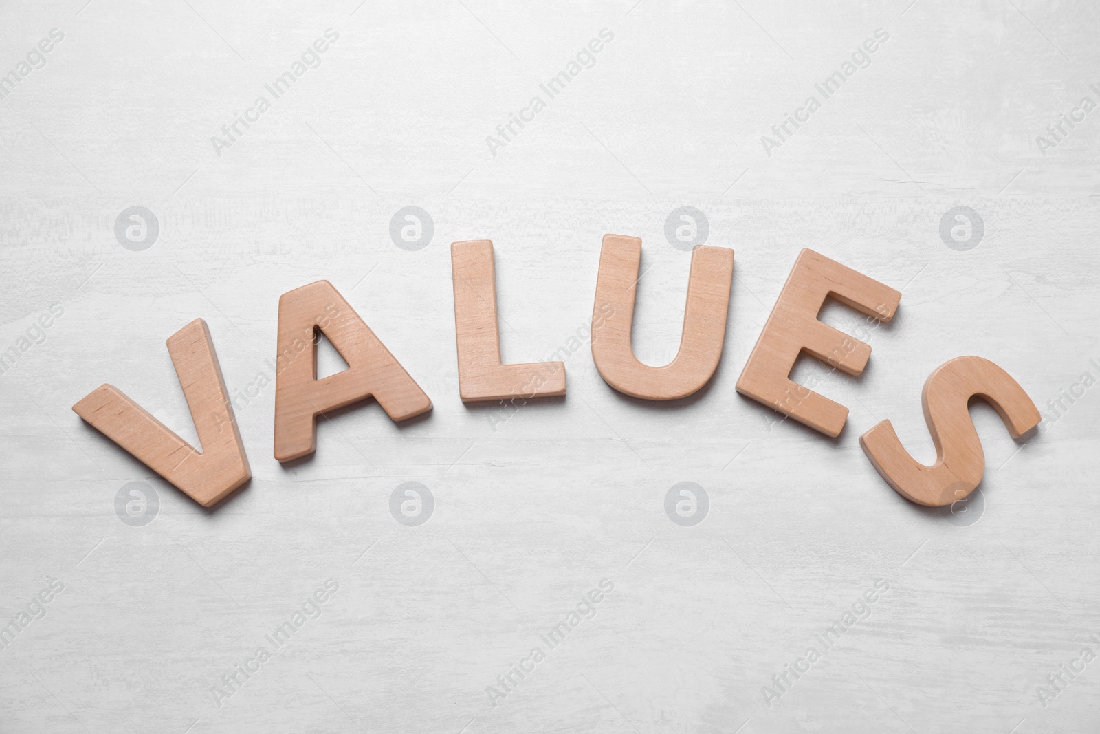 Photo of Word VALUES made of wooden letters on white background, flat lay