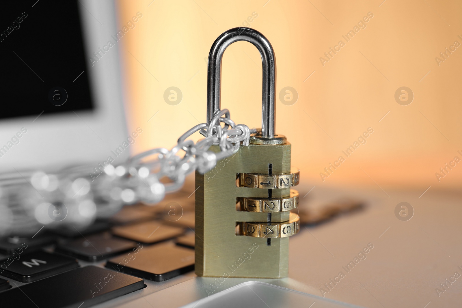 Photo of Cyber security. Padlock with chain on laptop, closeup