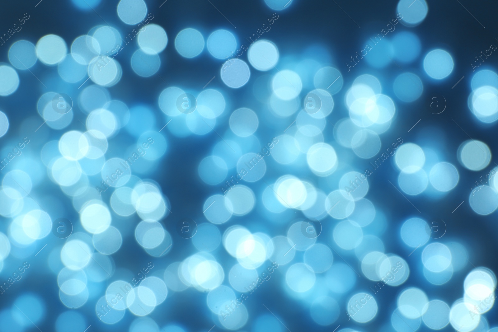 Photo of Blurred view of Christmas lights on dark background