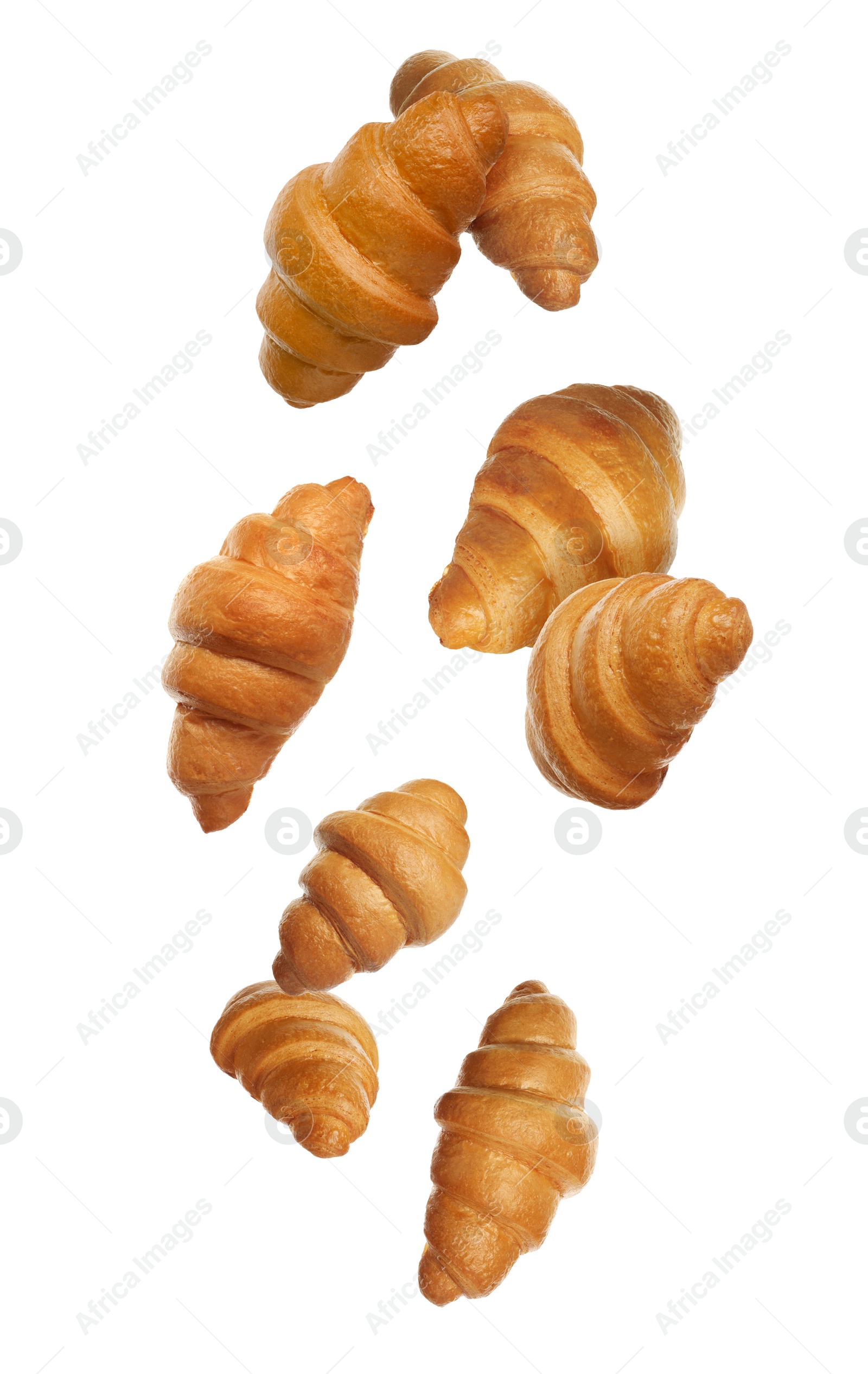 Image of Crusty golden croissants falling on white background