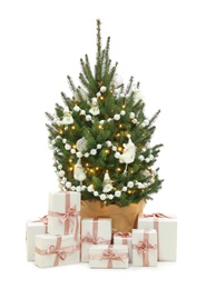 Photo of Beautiful decorated Christmas tree and gift boxes on white background