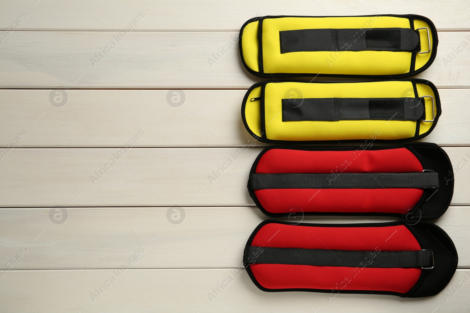 Photo of Different weighting agents on white wooden table, flat lay. Space for text