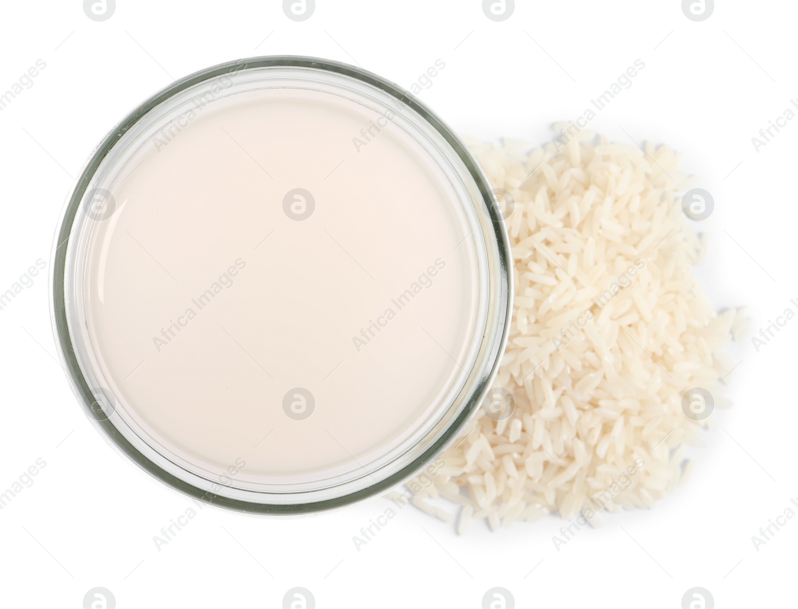 Photo of Homemade natural rice water and grains on white background, top view