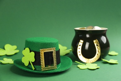 Photo of Leprechaun's hat and St. Patrick's day decor on green background