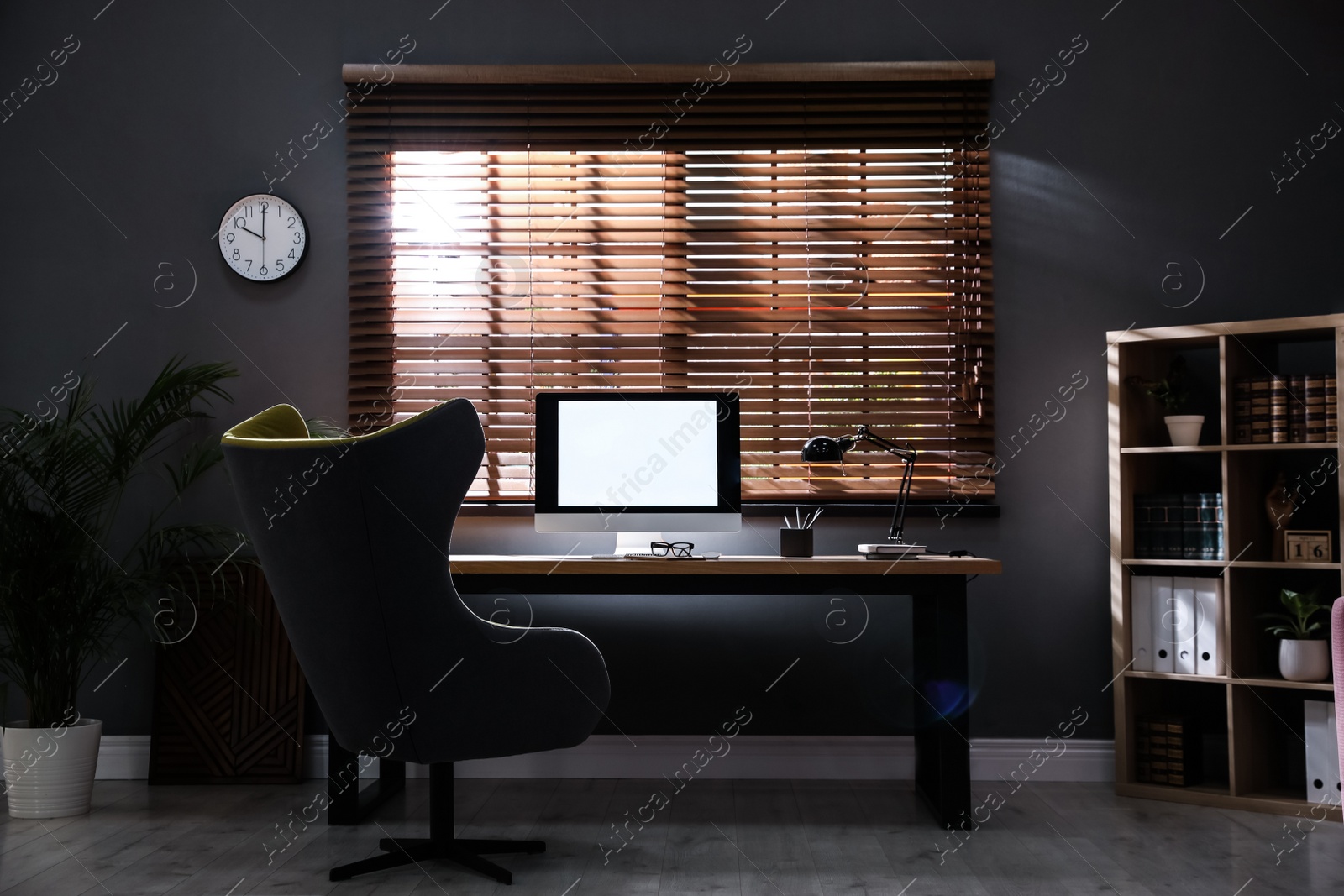 Photo of Stylish room interior with modern computer and comfortable office chair