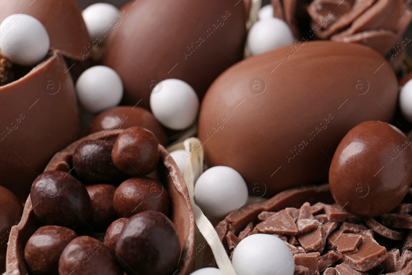 Photo of Tasty chocolate eggs and sweets as background, closeup