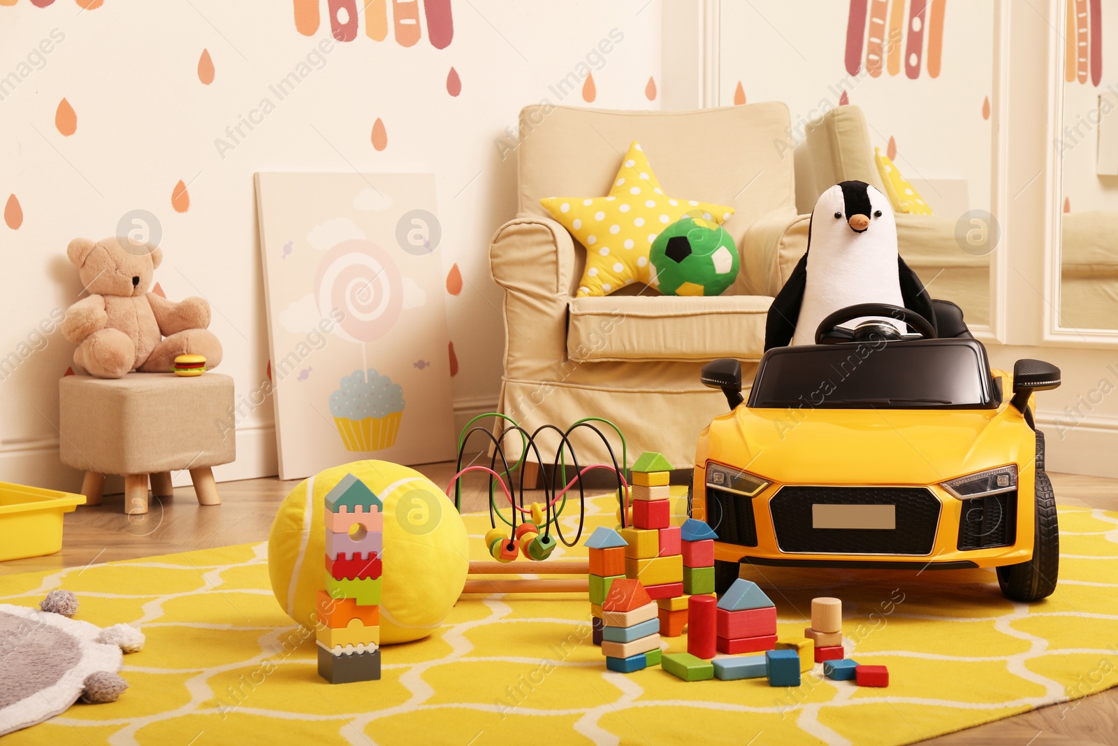 Photo of Child's electric car and other toys in playroom