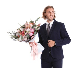 Young handsome man in stylish suit with beautiful flower bouquet on white background