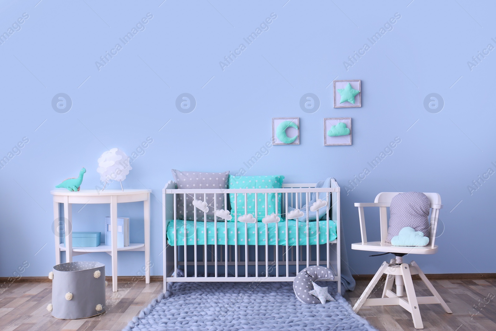 Photo of Baby room interior with crib near wall