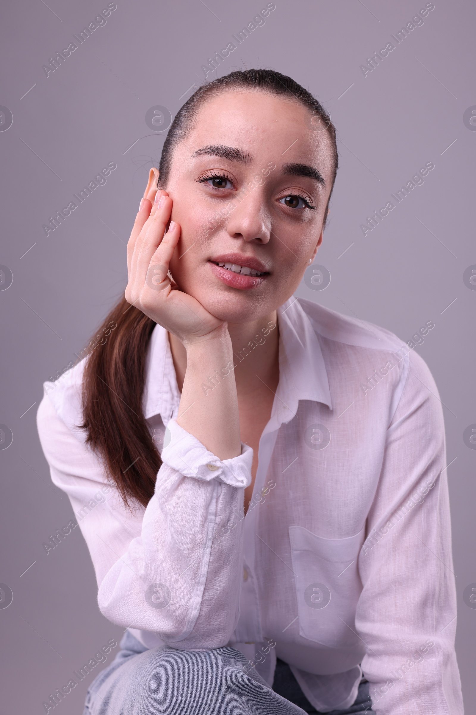 Photo of Portrait of happy young woman on light grey background