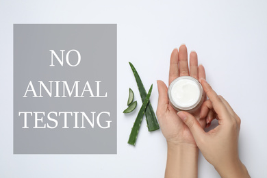 Image of Woman with jar of cream, aloe and text NO ANIMAL TESTING on white background, flat lay