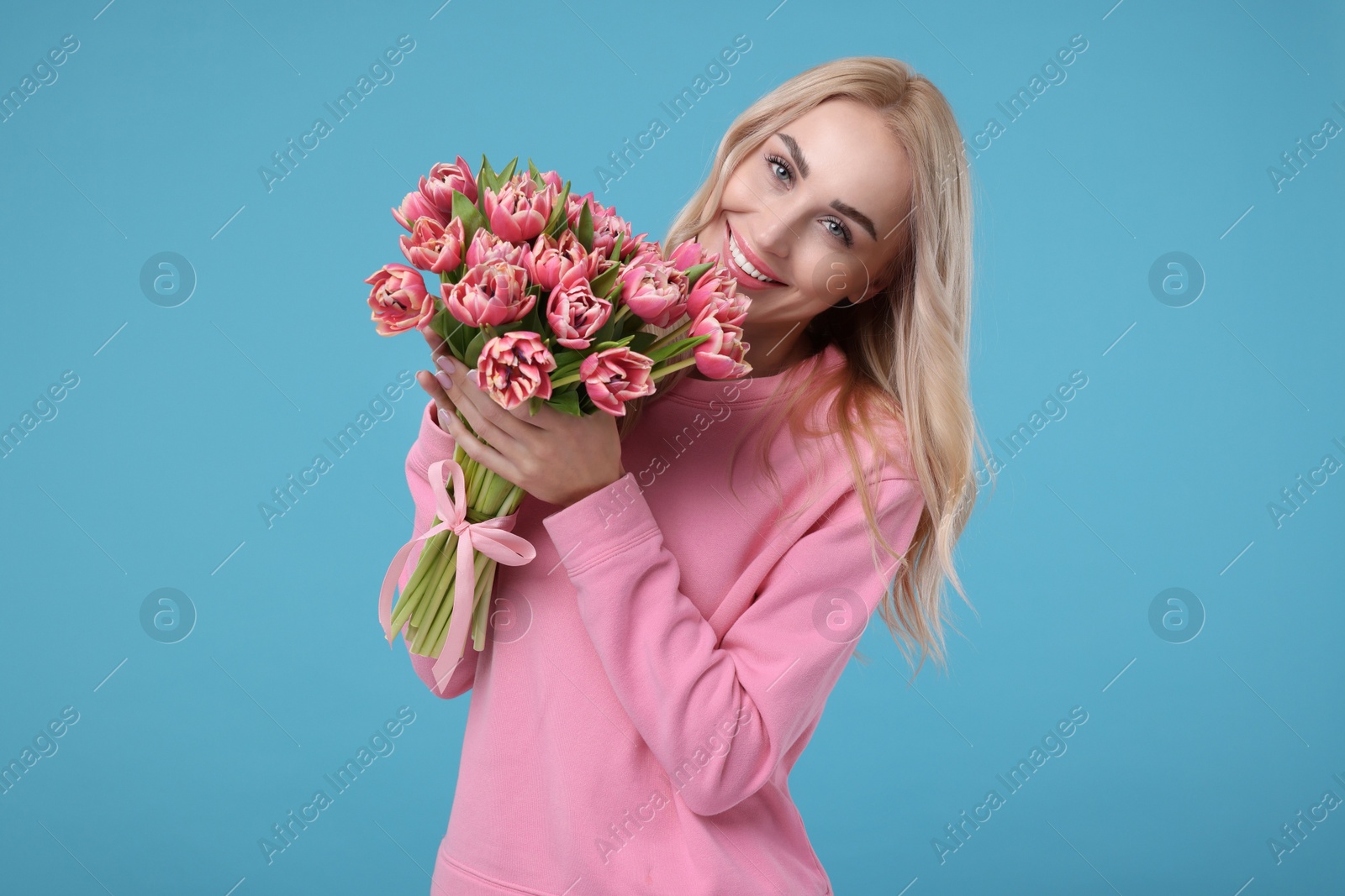 Photo of Beautiful young woman on light blue background