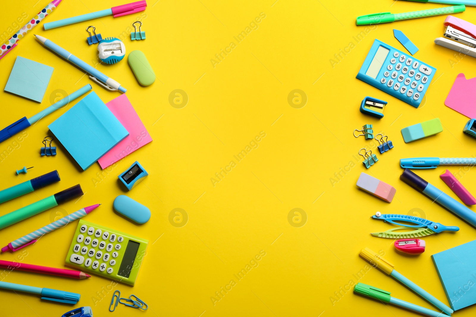 Photo of Frame of school stationery on yellow background, flat lay with space for text. Back to school