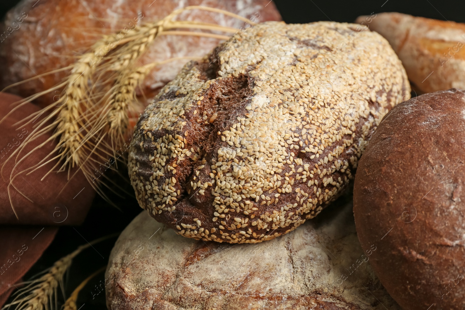 Photo of Different kinds of fresh bread as background, closeup