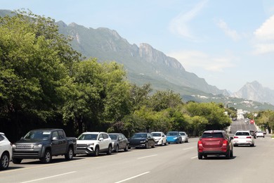 Photo of Picturesque view of mountains and highway with cars