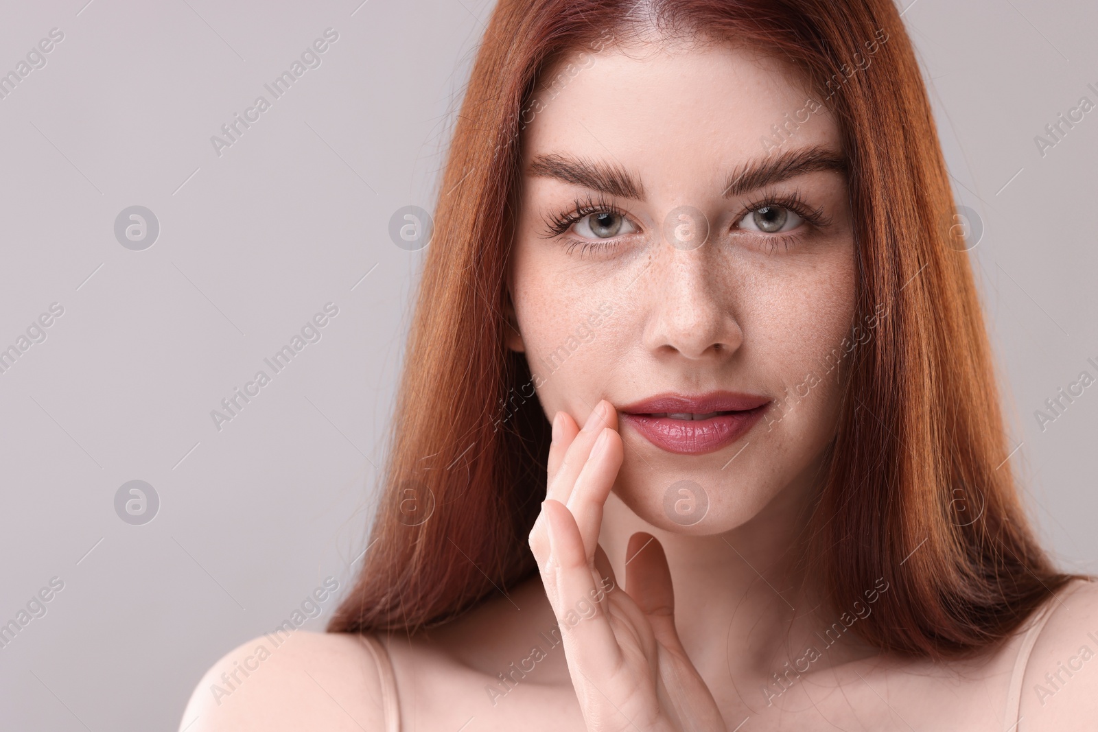 Photo of Portrait of beautiful woman on grey background, closeup