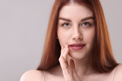 Portrait of beautiful woman on grey background, closeup