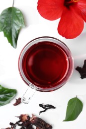 Flat lay composition with delicious hibiscus tea on white background