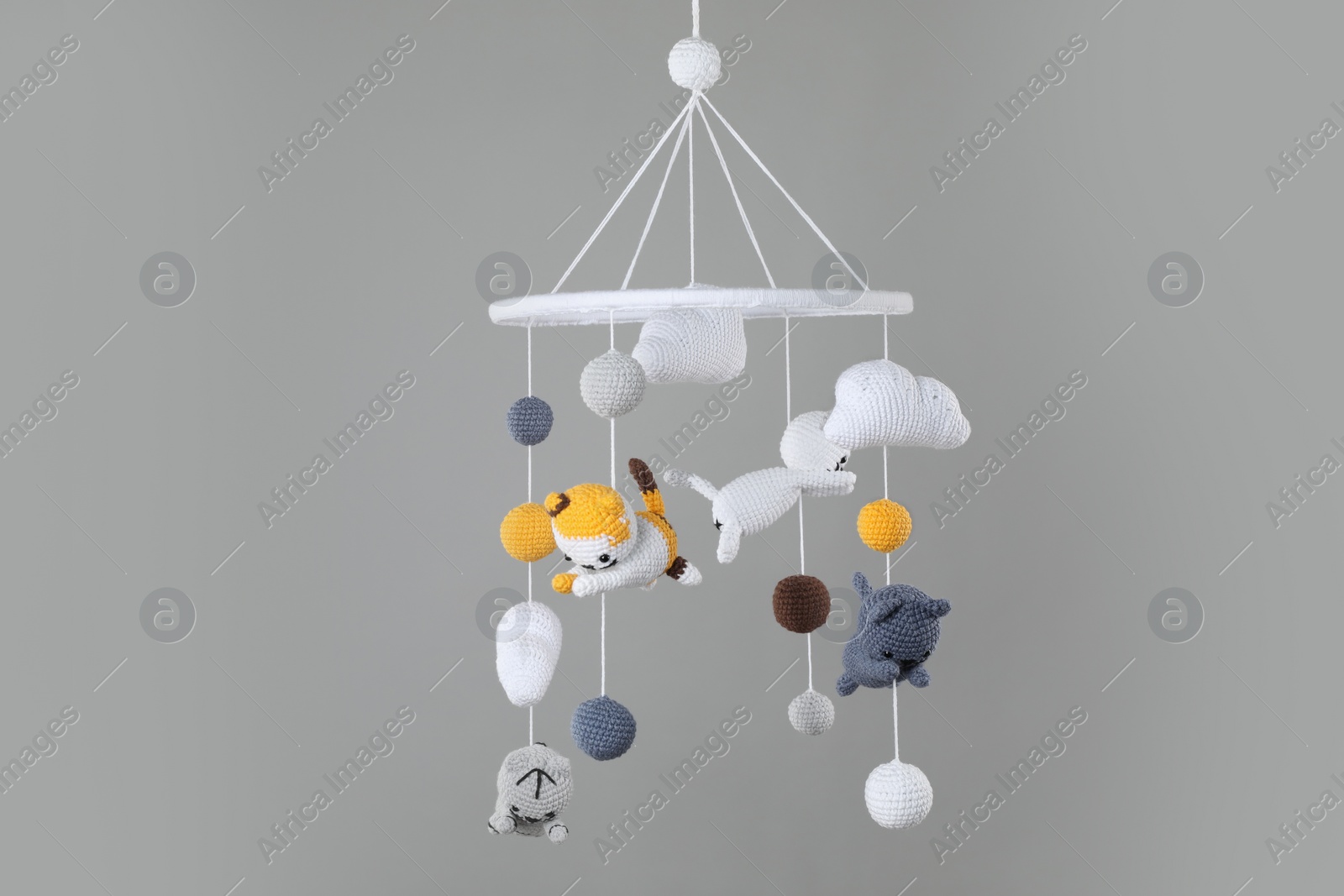 Photo of Cute baby crib mobile on grey background