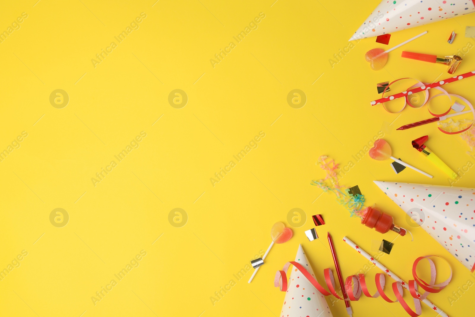 Photo of Party popper, blowers and festive decor on orange background, flat lay. Space for text