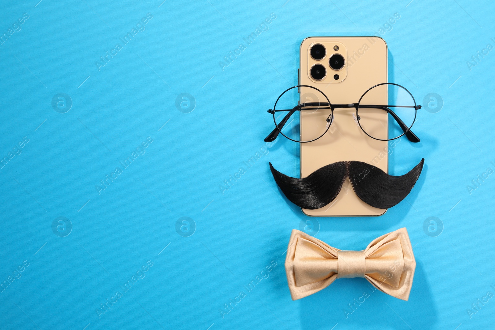 Photo of Flat lay composition with artificial moustache and glasses on light blue background, space for text