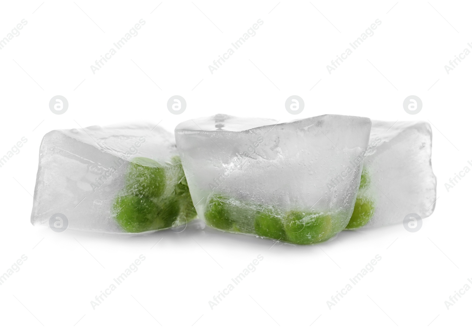 Photo of Green peas in ice cubes on white background. Frozen vegetables