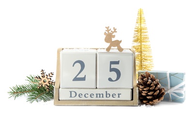 Wooden block calendar and festive decor on white background