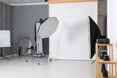 Photo of White photo background and professional lighting equipment in studio