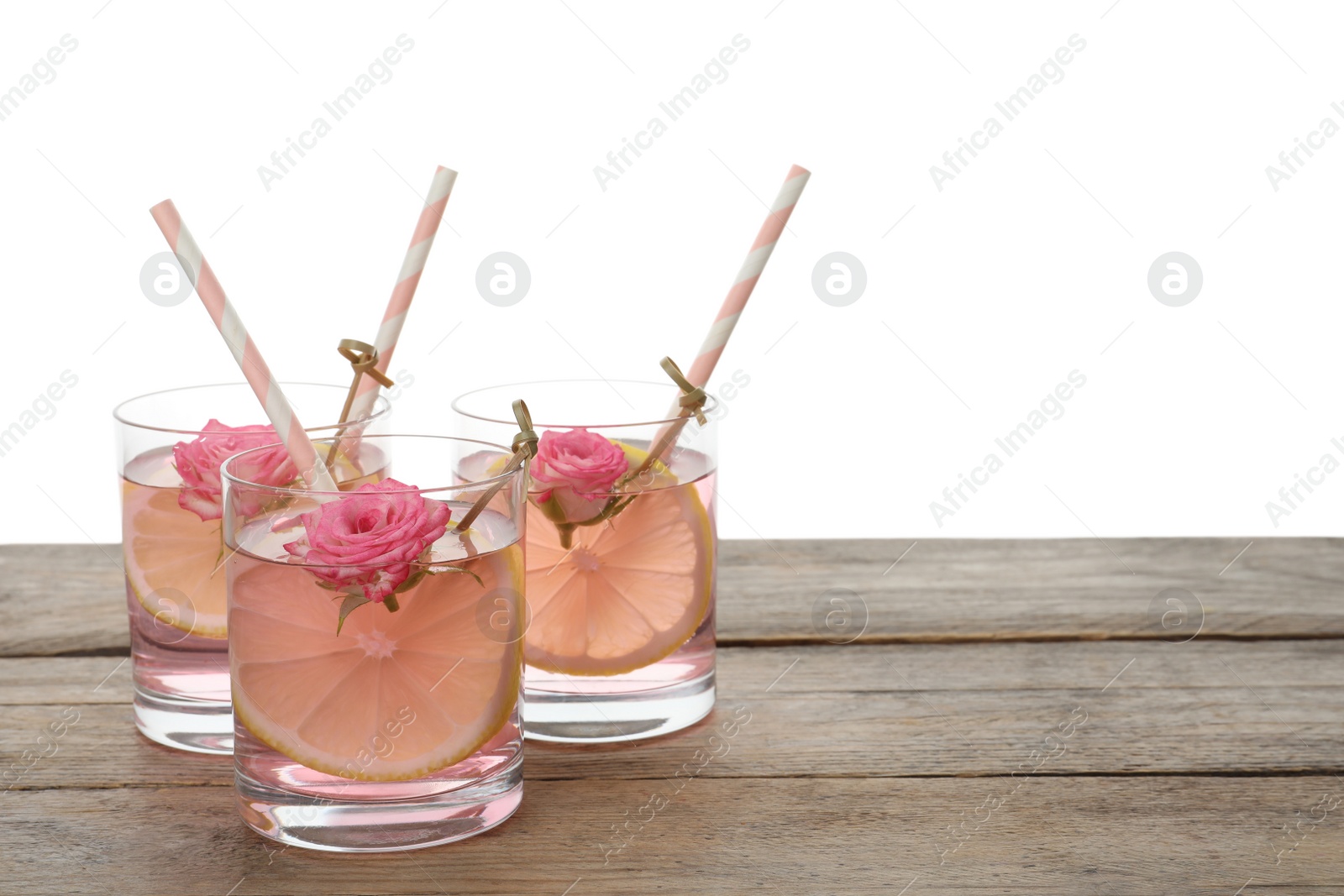 Photo of Refreshing drink with lemon and rose on wooden table