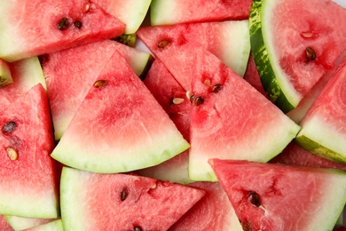 Photo of Many watermelon slices as background, top view