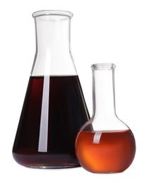 Photo of Laboratory glassware with brown liquids on white background