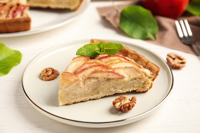 Photo of Slice of delicious apple pie on white wooden table