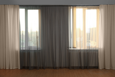 Windows with beautiful curtains in empty room