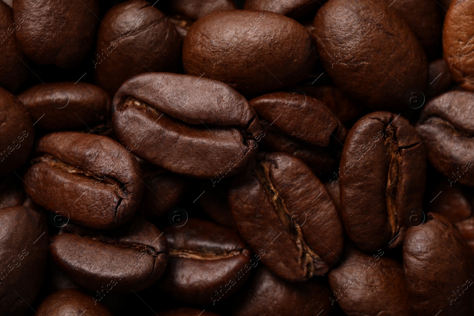 Photo of Aromatic roasted coffee beans as background, closeup