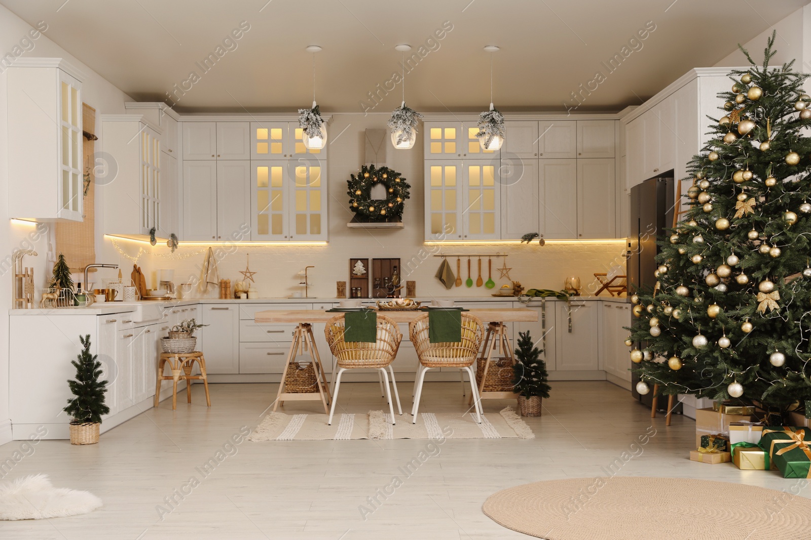 Photo of Cozy open plan kitchen decorated for Christmas. Interior design