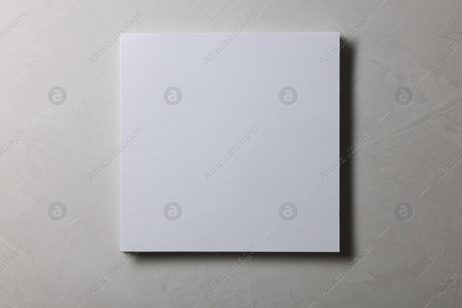 Photo of Blank paper sheets on grey textured background, top view. Mockup for design